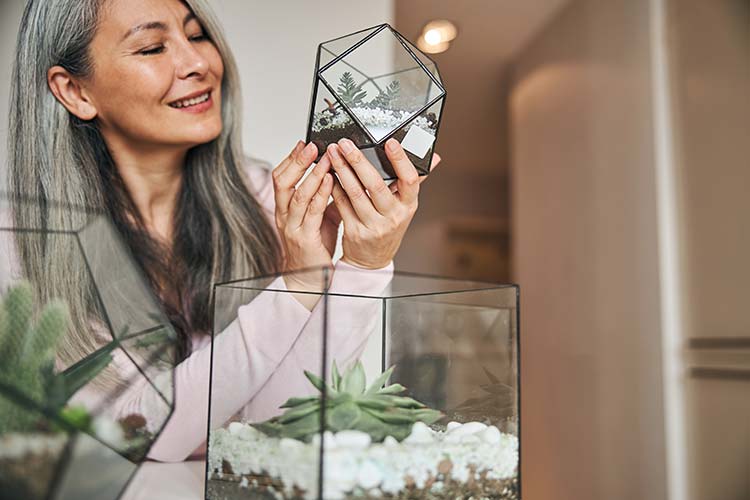 Our team member Ruby is holding a terrarium.