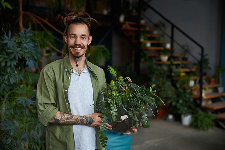 Our team member Trystan holding a terrarium.