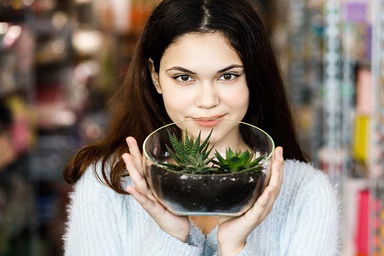 Our team member Willow is holding a terrarium.